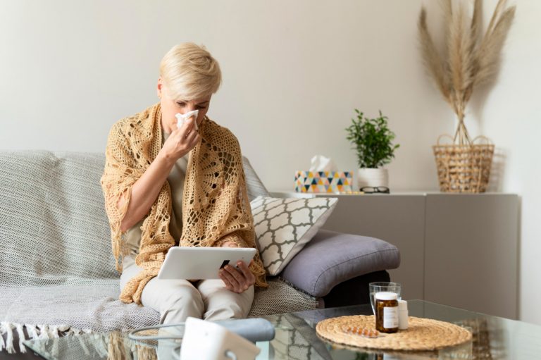 sick-woman-holding-tablet-medium-shot