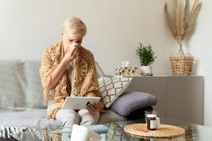 sick-woman-holding-tablet-medium-shot